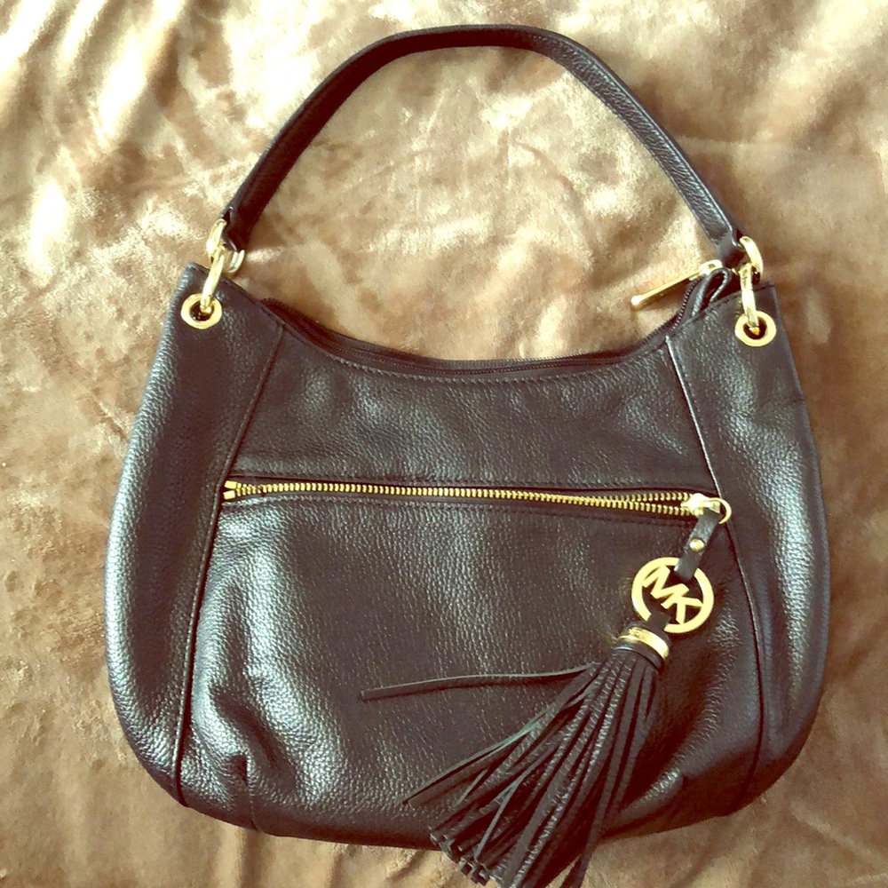 Black Michael Kors purse with gold trim.